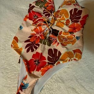 Brand New One piece swim suit. Detail ties, cheeky butt and low back.